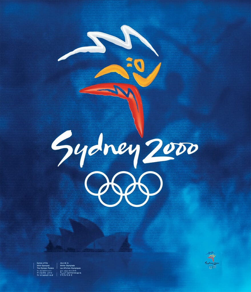 El afiche oficial de los juegos olímpicos de Sídney 2000: conceptual, bello y significativo tanto por el diseño explícito como por la silueta del aborigen oceánico al fondo, una obra muy a la altura de lo que fue finalmente ese evento. Y aquí se nota que la influencia estética de Barcelona 1992 no había muerto con el paréntesis forzado de Atlanta 1996.